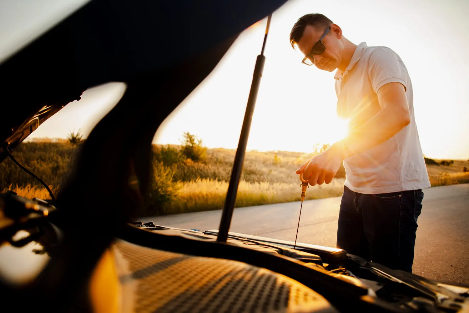 Checking engine oil levels can help prevent overheating during summer road trips