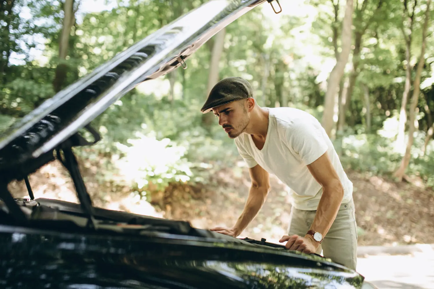 Diagnosing car noises: mechanic inspects engine to identify the issue