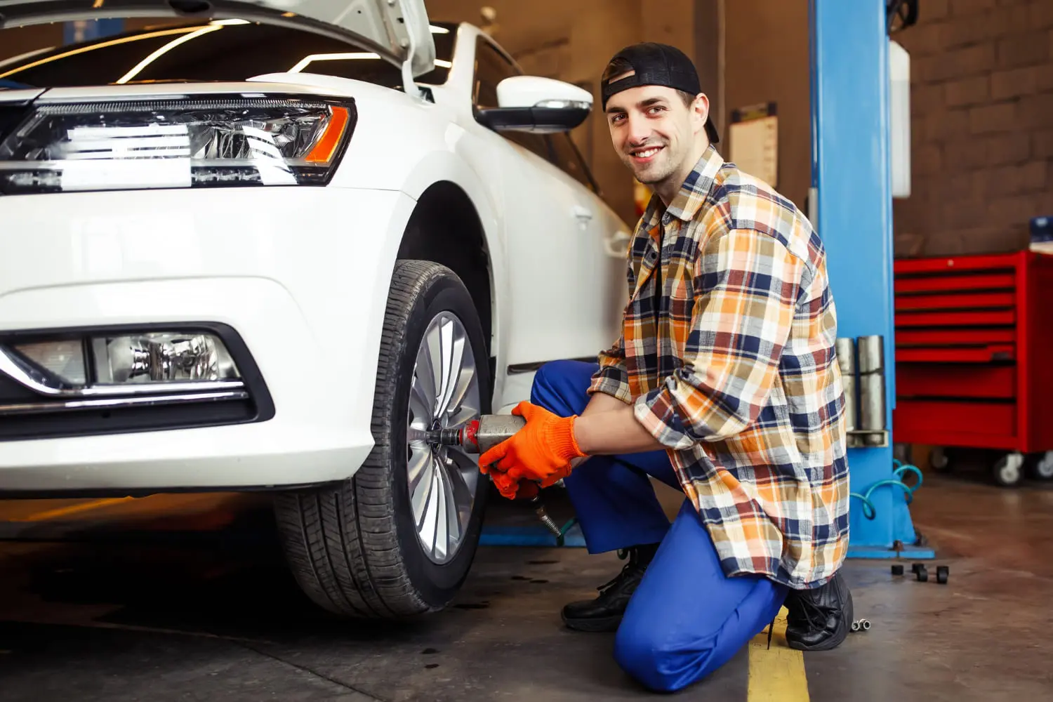 Person doing a simple DIY wheel maintenance task to save money on car shop bills