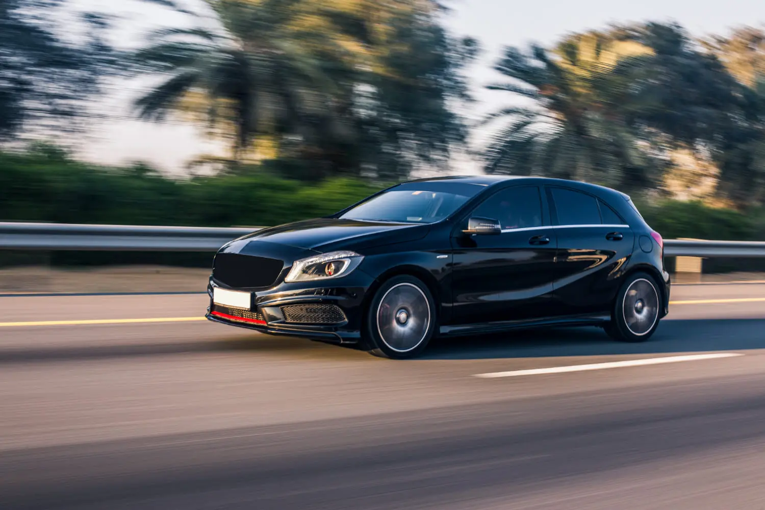 Performance compact hatchback driving at speed on a highway during daily commute