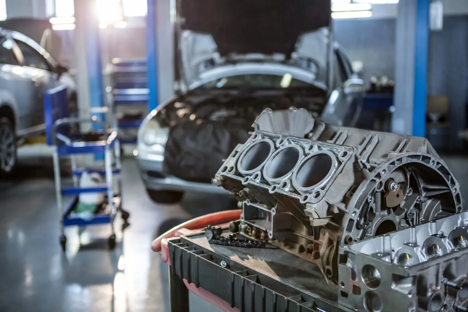Engine parts in an auto repair shop as import tariffs drive up spare part prices